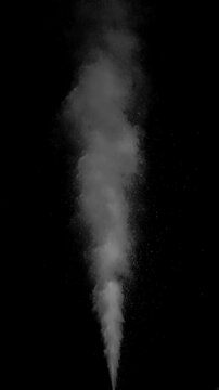 Hot Steam Plume Rising on Black. Vertical slow-motion of hot steam powerfully rising from below, forming a tall turbulent column that expands, gradually dissipates into fine sparkling particles.