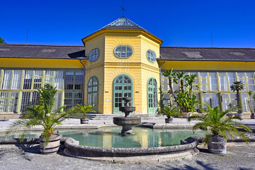 Obraz premium Historic Orangery Building and Water Fountain at Esterhazy Palace Park in Eisenstadt Austria