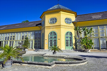 Obraz premium Orangery Glasshouse Architecture with Stone Fountain at Esterhazy Palace Park in Eisenstadt Austria