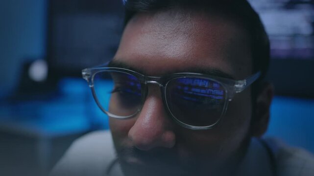 IT Professional Focusing on Data Stream with Eyewear Reflection