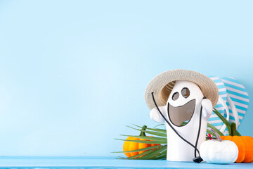 Summerween holiday background. Bright festive background for summer Halloween holiday in style of Halloween with summer decorations, pumpkins, ghost, bat, summer vacation accessories, tropical leaves © ricka_kinamoto