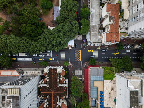 Aerial view of Square Nossa Senhora da Paz and the church with its cross-shaped roof surrounded by lush trees and city buildings in Rio de Janeiro, Rio de Janeiro, Brazil.