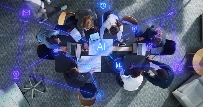 Top Down View of Businesswomen and Businessmen Meeting Around Office Desk With Laptops and Reports as Linked Visualization of Glowing Icons Statistics, Cybersecurity, SAAS and AI.