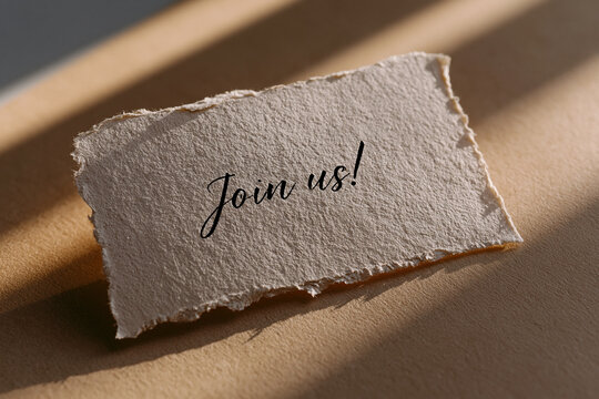 Join Us Message On Torn Paper Card With Soft Sunlight Shadow