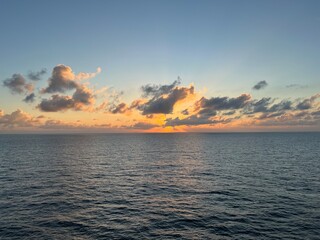 Fototapeta premium Tropical sunset with glowing clouds over the sea