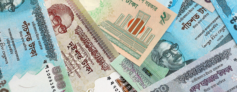 Bangladeshi taka money banknotes pile on table. Bangladesh bills of BDT currency close up