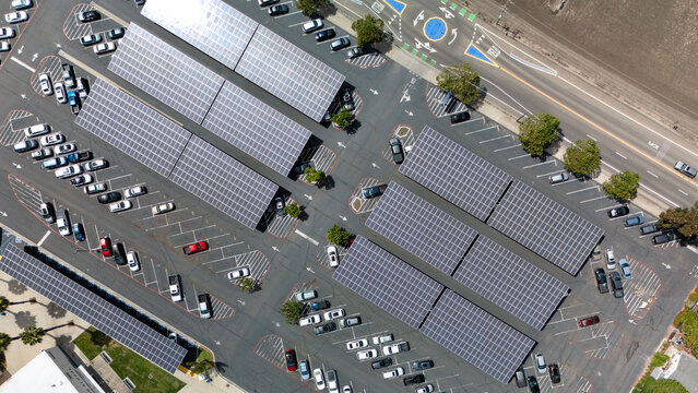 Angled drone view of solar panel carports over a large parking lot