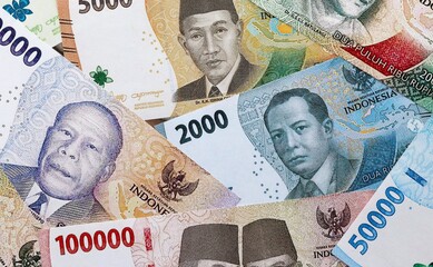 Indonesian rupiah money banknotes pile on table. Indonesia bills of IDR currency close up © Larysa