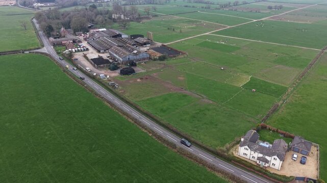 Aerial video showing farmland fields across a calm countryside scene.