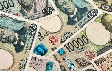 Japanese yen money banknotes pile on table. Japan bills of JPY currency. Concept of economy © Larysa