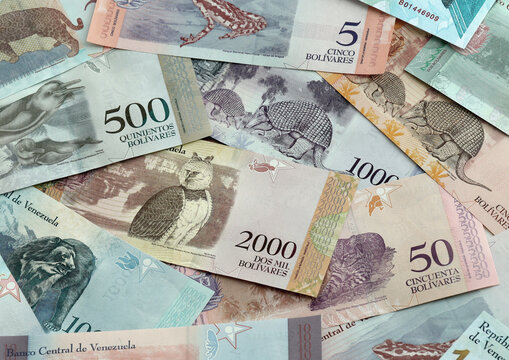 Venezuelan bolivar money banknotes pile on table. Venezuela bills of VES currency close up