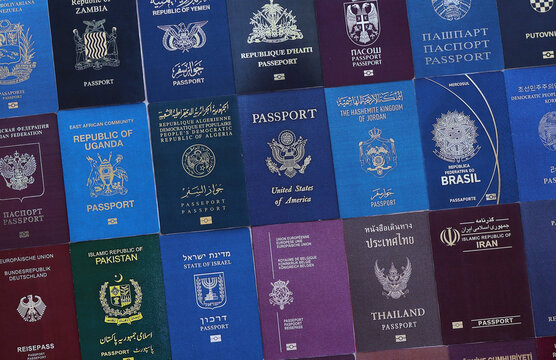Big amount of passport covers from many biometrical passports close up. Travel concept