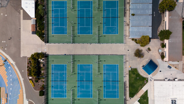 Top down drone view of tennis courts and athletic track
