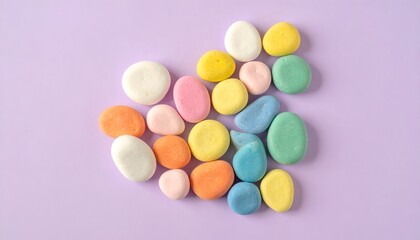 Obraz premium Colorful, rounded, pastel candies arranged on a soft purple background