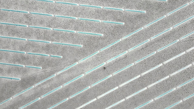 Aerial view of the geometric turquoise water channels and white salt crust of Salinas Grandes, Tumbaya, Jujuy, Argentina.