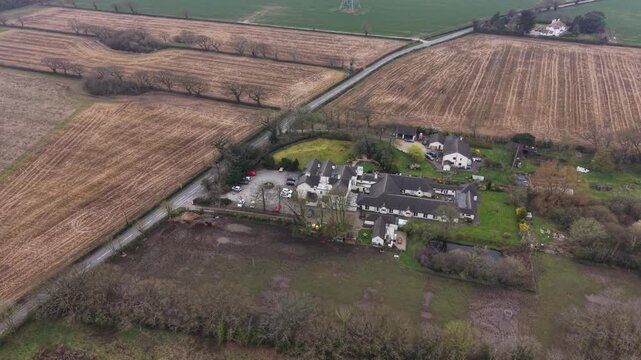 Aerial image showing farmland fields with woodland in a natural rural area.