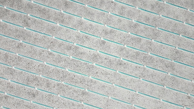 Aerial view of Salinas Grandes salt flats with geometric patterns of turquoise water channels and white salt crust Tumbaya, Jujuy, Argentina.
