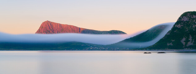 Panoramic view on the fjord during midnight sun in Lofoten islands, Norway. Long exposure. Scenic arctic summer landscape with golden hour light and northern nature. © biletskiyevgeniy