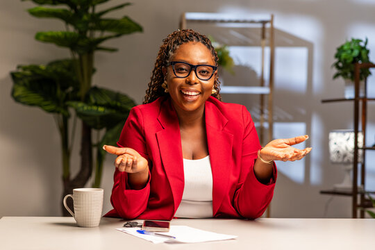 Young African businesswoman, team leader, coach and HR manager speaking to web camera during online job interview, virtual video conference meeting and corporate webinar in office.