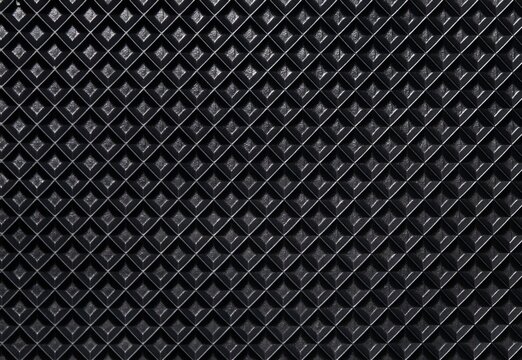 Macro shot of a black rubber running belt texture from a treadmill. Top view of non-slip embossed diamond pattern surface for sports equipment and fitness concepts.