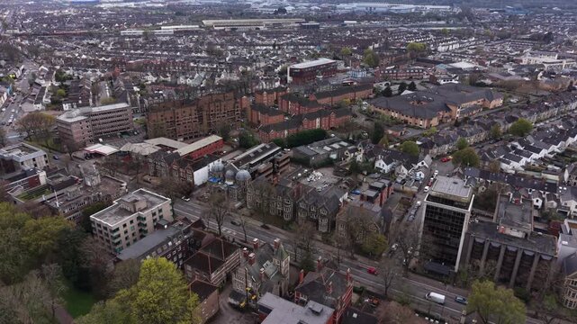 4K aerial video showing Cardiff urban districts with buildings, roads, and bright natural daylight.