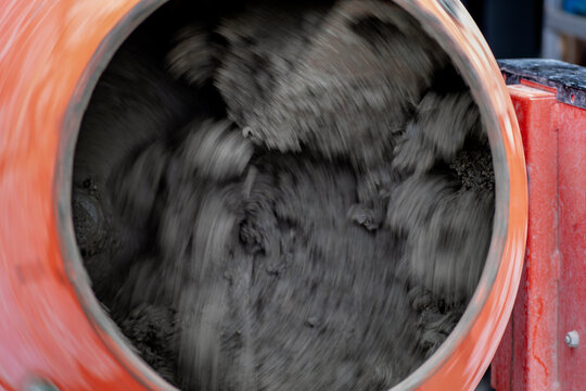 Concrete mixer mixing cement, sand and water to produce concrete