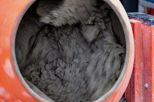 Concrete mixer mixing cement, sand and water to produce concrete