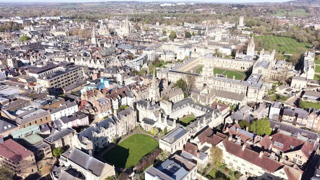 4K aerial video showing Oxford university architecture across a wide urban landscape in clear daylight.