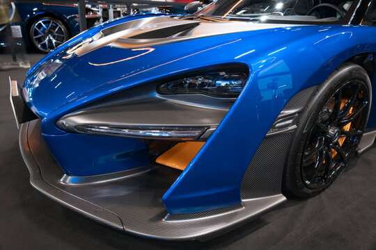 Front section of a McLaren supercar featuring aggressive aerodynamics, futuristic lines, and extreme four-wheel performance.