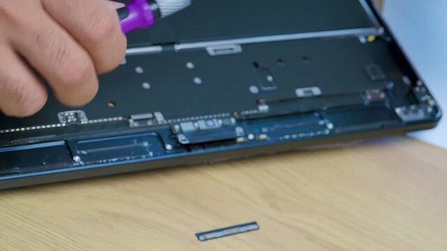 Hands Repairing Opened Laptop