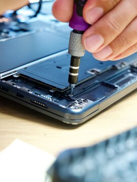 Hands Repairing Opened Laptop