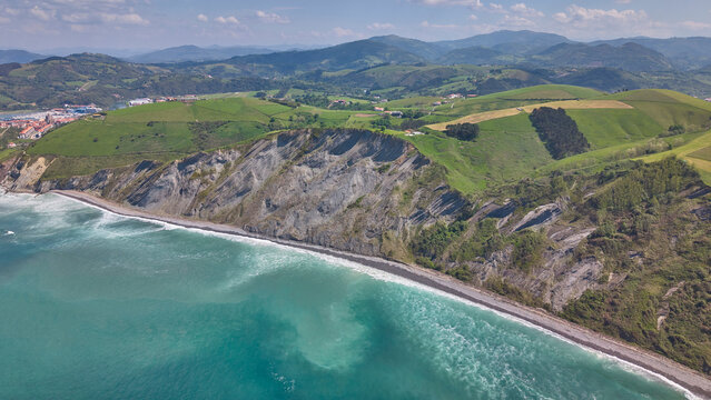 Rocky coastline and green cliffs aerial landscape