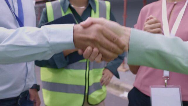 Close up of construction workers handshake