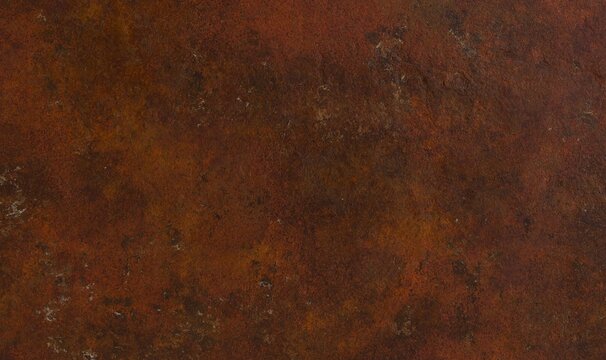 A close-up of a rusty metal surface with a predominantly reddish-brown hue and textured appearance