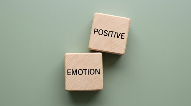 Two wooden blocks with the words 'positive emotion' signifying a good feeling or mood