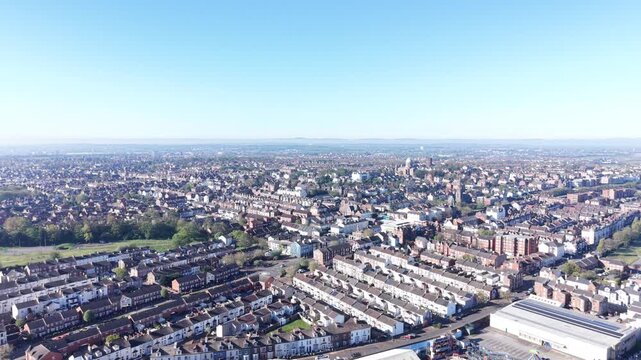 A natural 4K video showing tidal movement across the New Brighton shoreline, with sandy beach foreground and an expansive estuary horizon under clear daylight.
