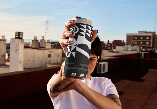 Woman Holding Tall Can on Rooftop in Sunlight