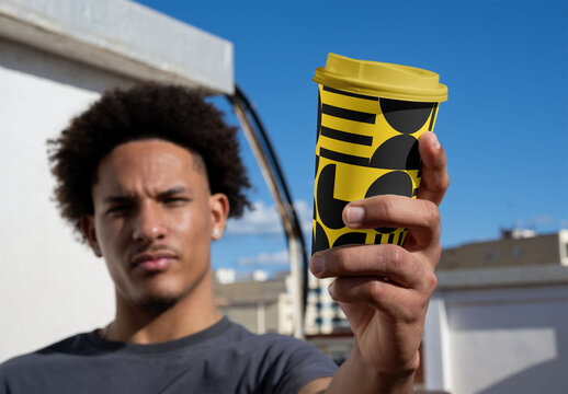 Mockup of Eco Disposable Cup Held by young man