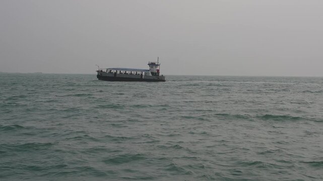 Passenger Boat on Open Sea under Cloudy Sky