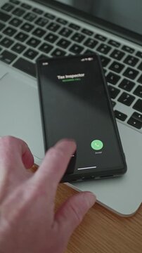 Man hand repeatedly pressing decline button on smartphone during incoming call from tax inspector
