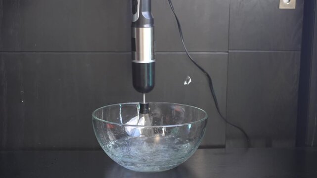 Mixer blender attachment blending liquid in a glass bowl in close up. Uncompressed 24 bit high quality sound.