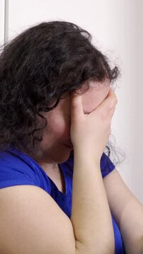Upset problem woman with head in hands sitting on floor concept for bullying, depression stress or frustration at workplace