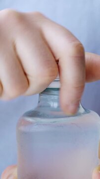 Close up of female hand pain while opening Plastic Bottles of water.Concept of no stuck cap when opening a bottle of water