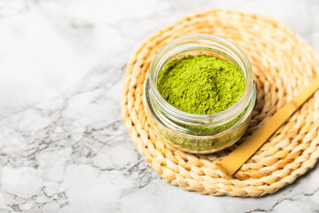 Obraz premium Preparing matcha tea. Ceramic cup with bamboo whisk and matcha powder. Detox. Organic matcha tea powder. Flat lay. Space for text. Texture. Copy space
