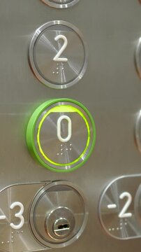 Cropped shot of a man pressing a zero button in an elevator