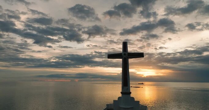 Sunken Cemetery in Camiguin Island. Cloudscape with sunset and boat in background. Philippines.