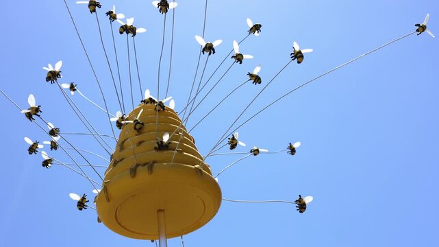 Bee Hive Garden Element Sways In Sunlight.
