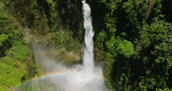 Beautiful landscape with tropical falls and rainbow on a tropical river in the mountains. Lake Sebu. Mindanao, Philippines.