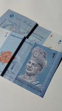 Close-up view of a Malaysian one Ringgit banknote featuring detailed currency texture and financial concept imagery.