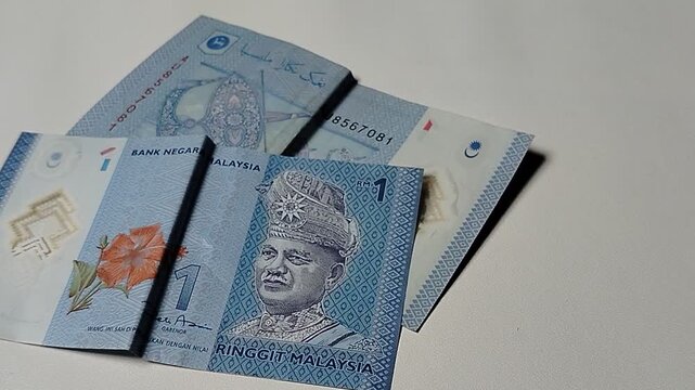 Close-up view of a Malaysian one Ringgit banknote featuring detailed currency texture and financial concept imagery.